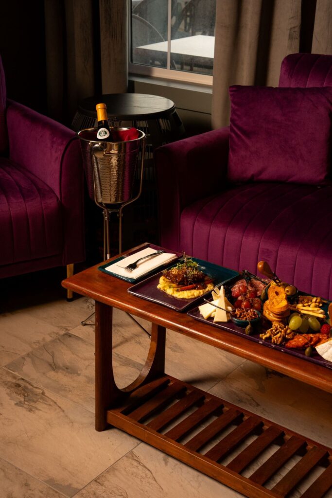 Short ribs and charcuterie on table in front of couch